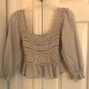 Cream color, crochet in front of top.